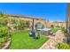 Beautifully landscaped backyard featuring a hot tub, seating area, and vibrant plants and flowers at 8269 Skye Peak St, Las Vegas, NV 89166
