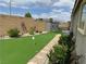 Backyard featuring a putting green, desert landscaping, and a storage shed at 8269 Skye Peak St, Las Vegas, NV 89166