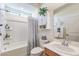 Cozy bathroom with a tub, shower, and white vanity with plant accent at 8269 Skye Peak St, Las Vegas, NV 89166