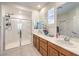 Beautiful main bathroom boasts double sinks, tile floors, and a glass-enclosed shower at 8269 Skye Peak St, Las Vegas, NV 89166
