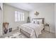 Bright bedroom featuring a queen bed, neutral decor, and natural light from the window at 8269 Skye Peak St, Las Vegas, NV 89166