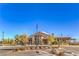 Beautiful community clubhouse featuring stone accents, lush landscaping, and ample parking for residents at 8269 Skye Peak St, Las Vegas, NV 89166