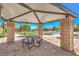 Community shelter with a picnic table and stone columns, ideal for outdoor gatherings and relaxation at 8269 Skye Peak St, Las Vegas, NV 89166