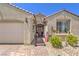 Inviting home entrance with brick walkway, decorative accents, and a well-manicured garden area and a two-car garage at 8269 Skye Peak St, Las Vegas, NV 89166