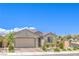 Attractive single story home featuring desert landscaping, muted exterior color palette, and an attached two-car garage at 8269 Skye Peak St, Las Vegas, NV 89166