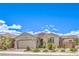 Inviting single-story home featuring a well-maintained front yard, mature desert landscaping, and an attached two-car garage at 8269 Skye Peak St, Las Vegas, NV 89166