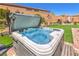 Inviting hot tub in a landscaped backyard, perfect for relaxation and outdoor entertaining at 8269 Skye Peak St, Las Vegas, NV 89166