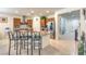 Well-lit kitchen with a granite-topped island, bar stool seating, and stainless steel appliances, opening to the home's entryway at 8269 Skye Peak St, Las Vegas, NV 89166