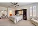 Large main bedroom features a ceiling fan, shuttered windows, and ensuite bathroom access at 8269 Skye Peak St, Las Vegas, NV 89166