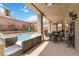 Spacious backyard with a swimming pool, outdoor seating, and a covered patio for entertaining at 8275 Old Creek Ranch St, Las Vegas, NV 89139