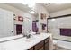 Well-lit bathroom with a wide mirror, modern vanity, and combined shower and tub at 8275 Old Creek Ranch St, Las Vegas, NV 89139