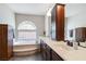 This bathroom features a soaking tub, double sink vanity, and spacious cabinets at 8275 Old Creek Ranch St, Las Vegas, NV 89139