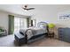 Cozy bedroom features carpet, ceiling fan, and curtains on sliding glass doors at 8275 Old Creek Ranch St, Las Vegas, NV 89139