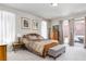 The primary bedroom features plush carpet, a decorative furniture set, and natural light at 8275 Old Creek Ranch St, Las Vegas, NV 89139