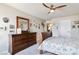 Bedroom with dresser, bed, and many framed photos on the wall at 8275 Old Creek Ranch St, Las Vegas, NV 89139