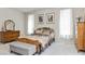 The primary bedroom features plush carpet, a decorative furniture set, and bright white walls at 8275 Old Creek Ranch St, Las Vegas, NV 89139