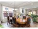 Elegant dining room with a large wood table and views into the living room at 8275 Old Creek Ranch St, Las Vegas, NV 89139