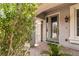 Charming front entrance with covered porch, manicured landscaping, and stylish front door at 8275 Old Creek Ranch St, Las Vegas, NV 89139