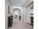 Upstairs hallway with archway, carpet, and decor, leading to bedrooms and bathrooms at 8275 Old Creek Ranch St, Las Vegas, NV 89139