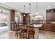 A chef's kitchen featuring an island, stone countertops, stainless steel appliances, and custom cabinetry at 8275 Old Creek Ranch St, Las Vegas, NV 89139