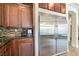 This kitchen showcases stainless steel appliances, and beautiful stone countertops and backsplash at 8275 Old Creek Ranch St, Las Vegas, NV 89139