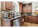 This kitchen features granite countertops, stainless steel appliances, and wood cabinets at 8275 Old Creek Ranch St, Las Vegas, NV 89139