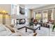 Comfortable living room with a fireplace and views of the backyard at 8275 Old Creek Ranch St, Las Vegas, NV 89139