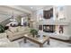 Cozy living room with fireplace, plush seating, and abundant natural light at 8275 Old Creek Ranch St, Las Vegas, NV 89139