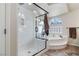 Luxurious main bathroom showcasing a glass shower, soaking tub, and natural light at 8275 Old Creek Ranch St, Las Vegas, NV 89139