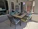 Covered patio with tile dining table and colorful cushioned chairs at 8275 Old Creek Ranch St, Las Vegas, NV 89139