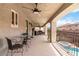 Relaxing covered patio features ceiling fans, seating and a spa at 8275 Old Creek Ranch St, Las Vegas, NV 89139