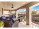 Comfortable covered patio with lounge seating and view of the community at 8275 Old Creek Ranch St, Las Vegas, NV 89139