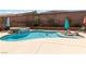 Backyard pool and hot tub with manicured landscaping and privacy wall at 8275 Old Creek Ranch St, Las Vegas, NV 89139