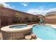 Backyard swimming pool with a hot tub feature and brick perimeter wall at 8275 Old Creek Ranch St, Las Vegas, NV 89139