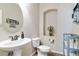 A well-lit powder room featuring a modern sink and neutral color palette at 8275 Old Creek Ranch St, Las Vegas, NV 89139