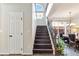 Elegant staircase with dark wood steps, iron railings, and natural light, leading to the upper level at 8275 Old Creek Ranch St, Las Vegas, NV 89139
