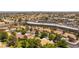 View of a neighborhood with single-story houses, tile roofs, mature landscaping, and nearby businesses at 8516 Millsboro Dr, Las Vegas, NV 89134