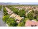 A well-maintained single-story home in a neighborhood with mature trees, tile roofs and landscaping at 8516 Millsboro Dr, Las Vegas, NV 89134