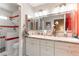 Well-lit bathroom with granite countertop, dual sinks, and modern shower at 8516 Millsboro Dr, Las Vegas, NV 89134