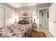 Bright bedroom with a beautiful quilt-covered bed, side tables and an inviting open doorway at 8516 Millsboro Dr, Las Vegas, NV 89134