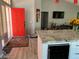 Modern entryway with a vibrant red door and a view of the kitchen at 8516 Millsboro Dr, Las Vegas, NV 89134
