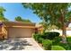 Well-maintained home featuring mature trees, front lawn and a two-car garage at 8516 Millsboro Dr, Las Vegas, NV 89134