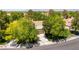 Aerial view of house with mature trees, large driveway, and desert landscaping at 8516 Millsboro Dr, Las Vegas, NV 89134