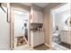 Hallway with access to laundry room and bathroom; both with tile flooring at 8516 Millsboro Dr, Las Vegas, NV 89134