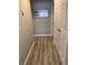 Hallway with light gray walls, hardwood floors, and doors to different rooms at 8516 Millsboro Dr, Las Vegas, NV 89134
