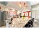 Bright kitchen boasts granite counters, pendant lighting, stainless appliances and breakfast bar seating at 8516 Millsboro Dr, Las Vegas, NV 89134