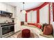 Cozy kitchen nook with built-in seating, ample natural light, and stainless steel appliances at 8516 Millsboro Dr, Las Vegas, NV 89134