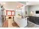 Open-concept kitchen with granite island, breakfast bar, and seamless flow to the living area at 8516 Millsboro Dr, Las Vegas, NV 89134