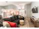Open-concept living room seamlessly connects to kitchen, with modern furniture and decor at 8516 Millsboro Dr, Las Vegas, NV 89134