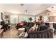 Open-concept living room with cozy sectional sofa, piano, shutters and access to the kitchen at 8516 Millsboro Dr, Las Vegas, NV 89134